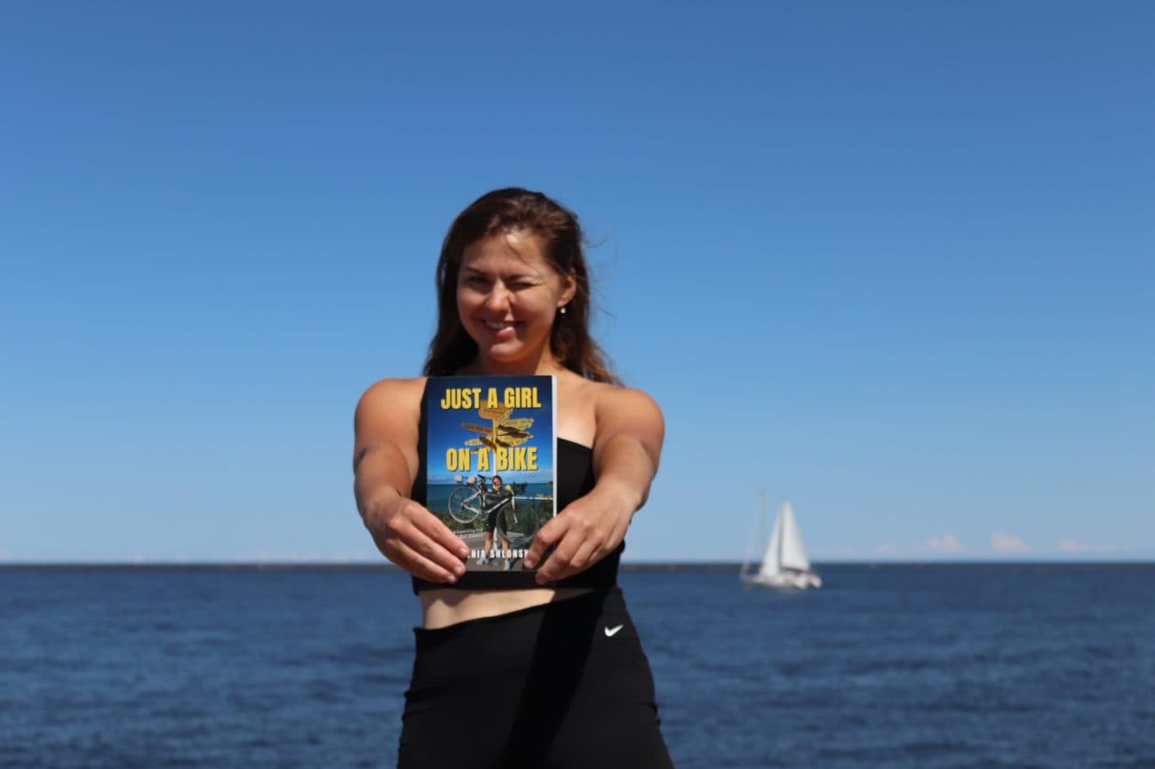 Evgenia holding a copy of the book by the sea